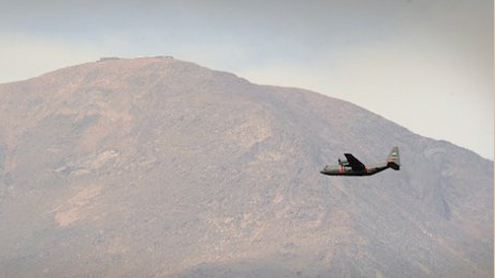 A C-130 flying past Pike's Peak in Colorado